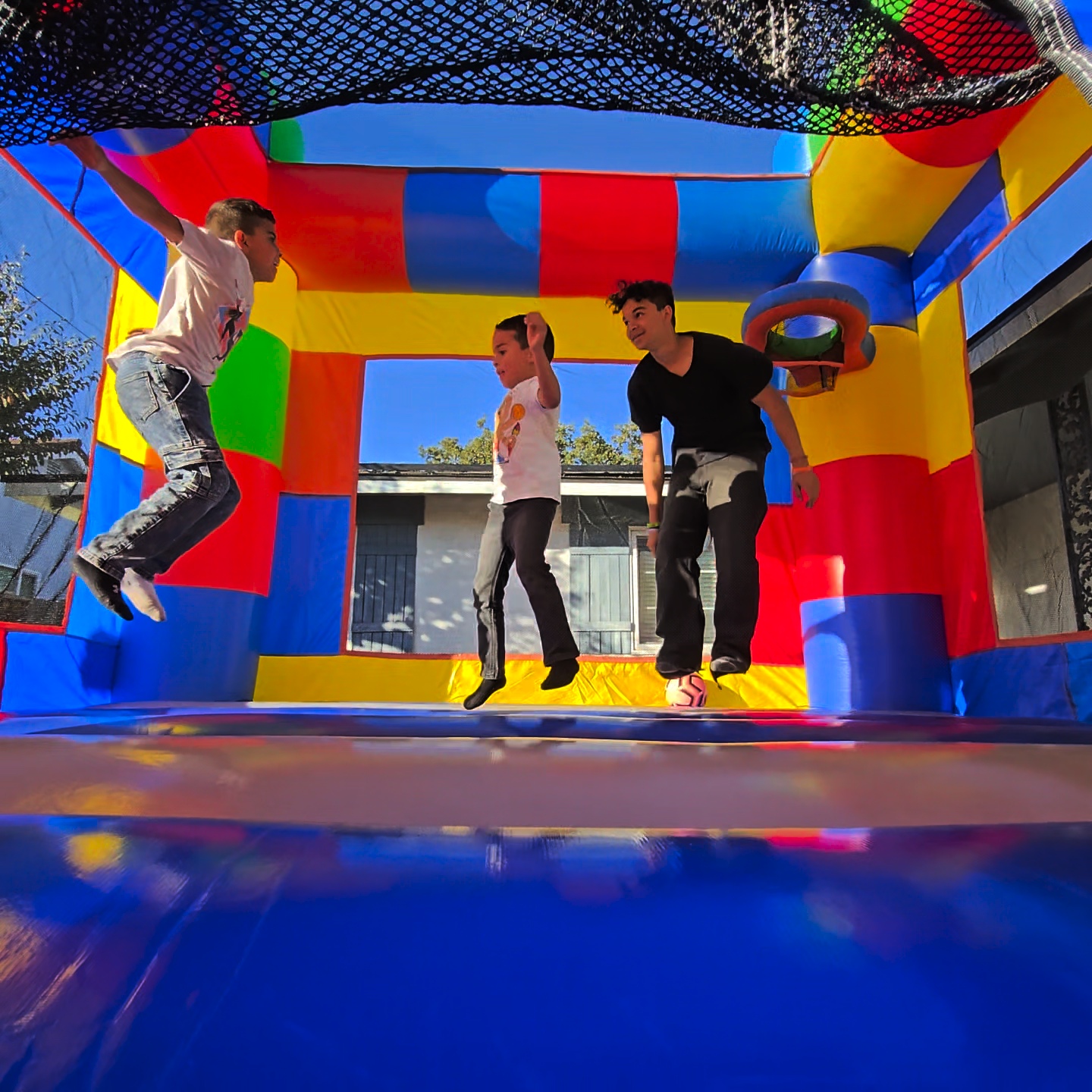 Kids jumping inside LEGO themed bounce house rental